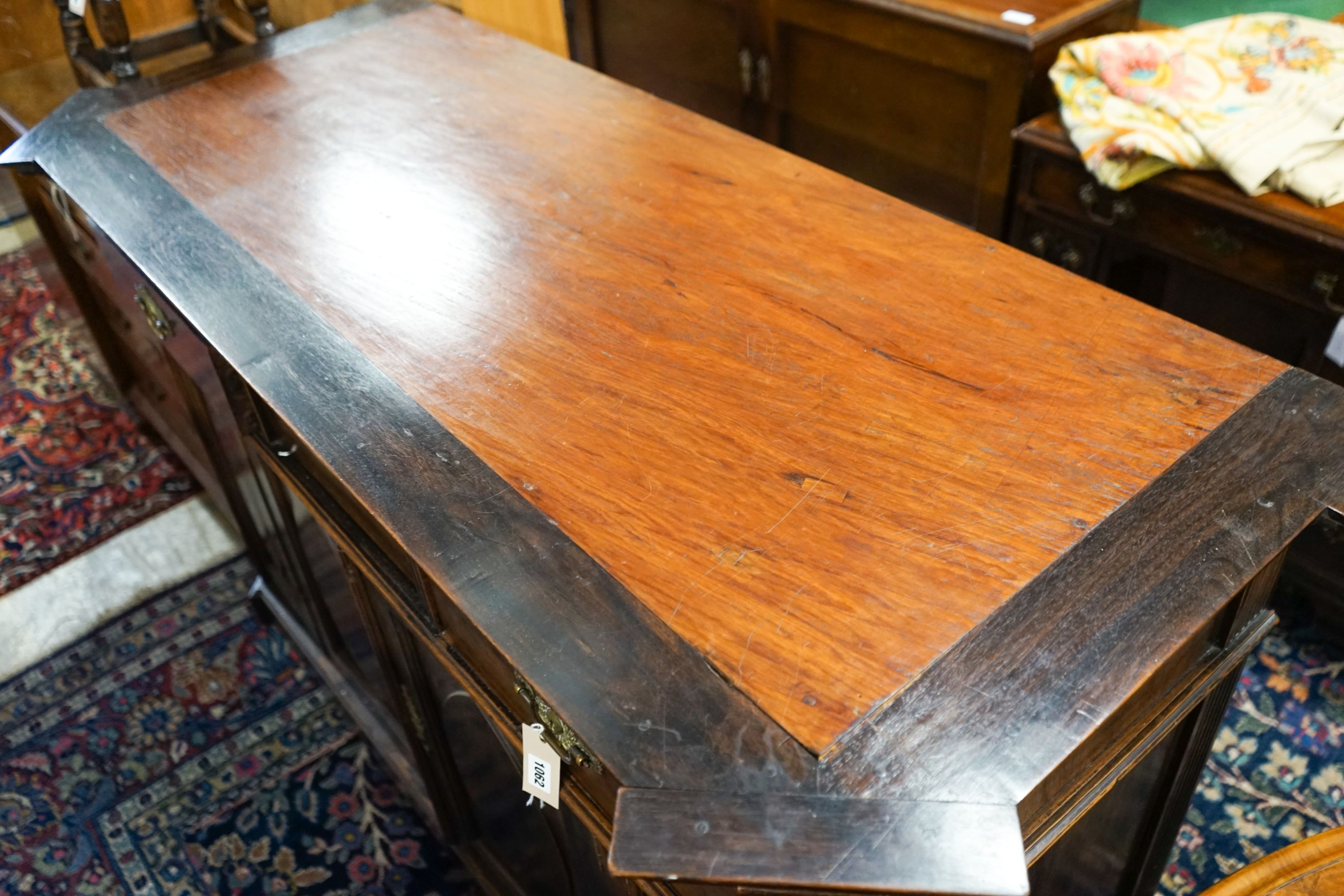 A 19th century Dutch mahogany sideboard, length 136cm, depth 56cm, height 104cm with raised shelved back over two frieze drawers and a pair of 'Gothic'-panelled cupboard doors, the top inset a pewter bowl